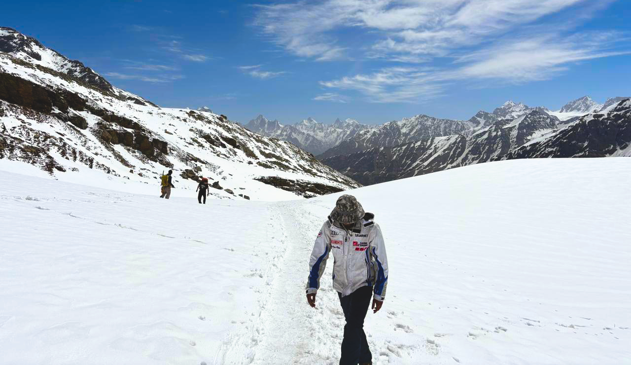 The Rupin Pass trail climbing through meadow toward distant snowfields