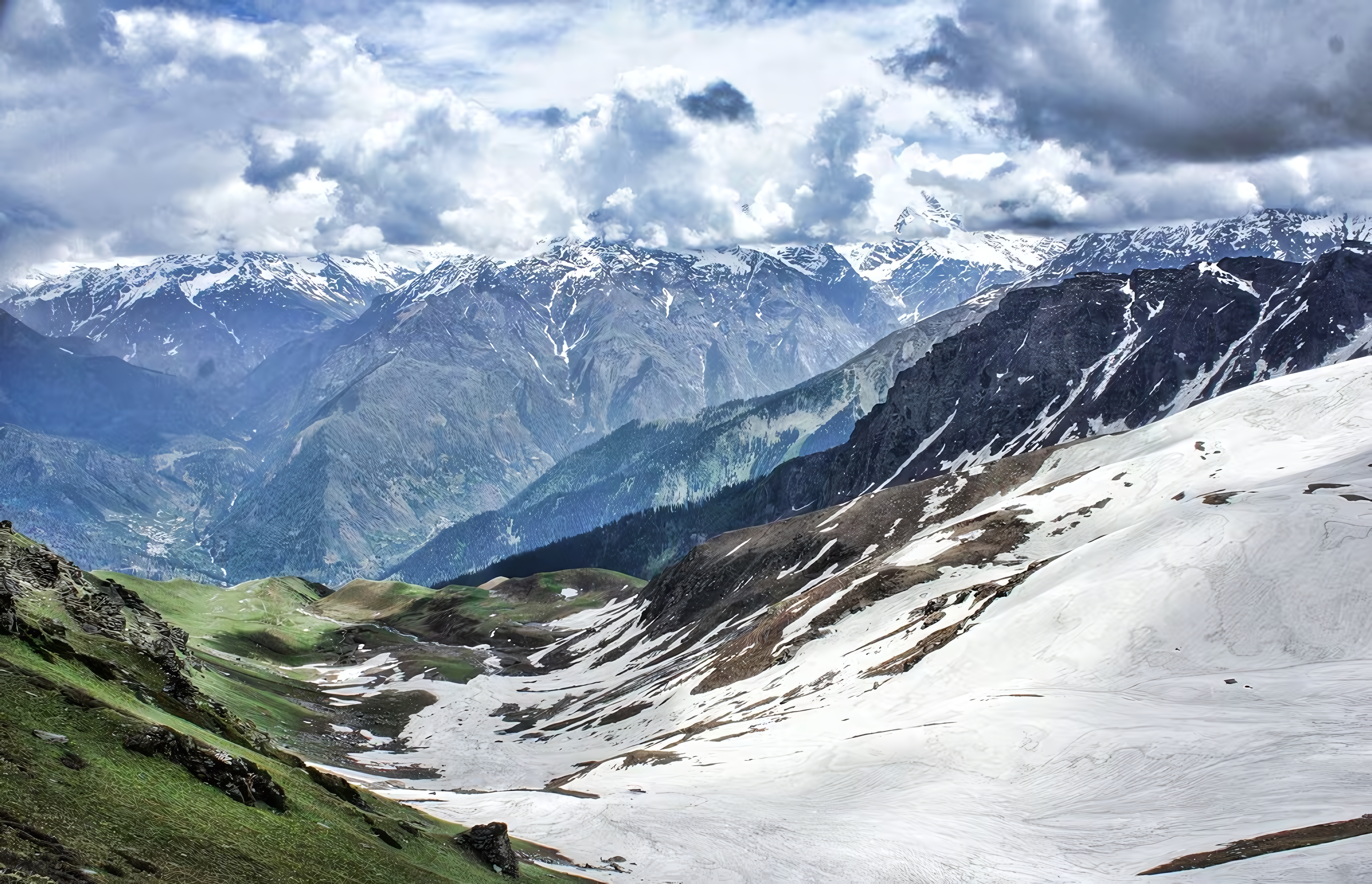 Wildflower meadow opening onto the grey peaks of Sar Pass